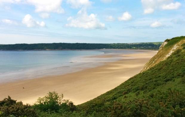 Golden sands of Oxwich Bay on a sunny day