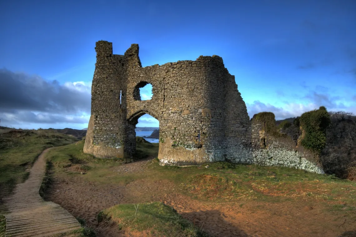 Pennard Castle ruins overlooking the valley and coast