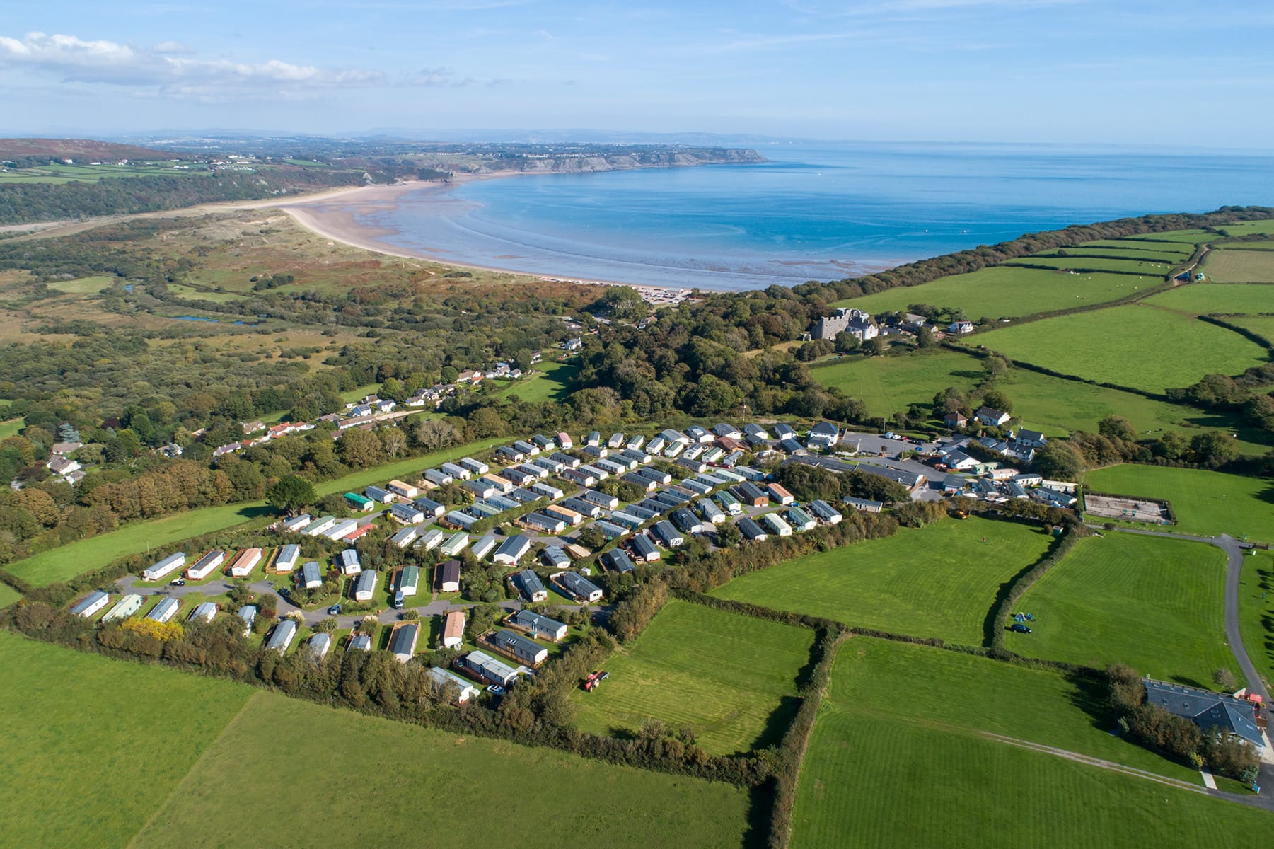 Aerial view over Greenways of Gower looking towards Oxwich Bay.